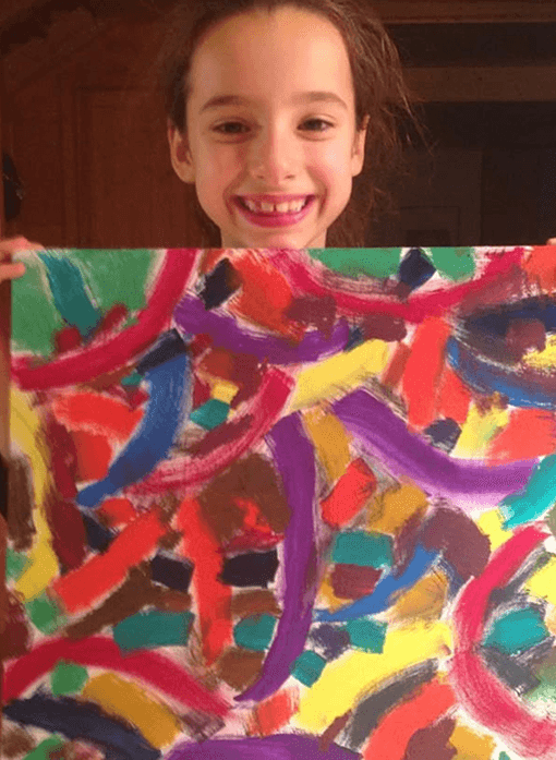 a girl with painting in her hand